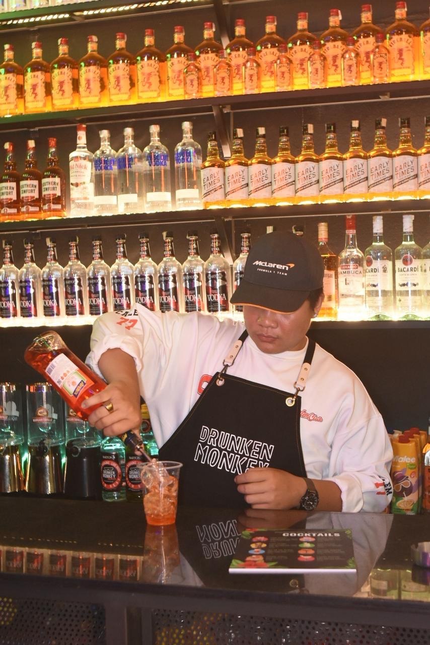 Bartender serving cocktails at Drunken Monkey Bar